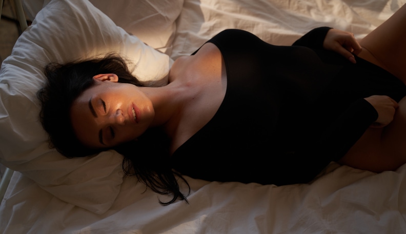 Seductive Woman In Black Underwear Sitting On Sexy Man In Bedroom